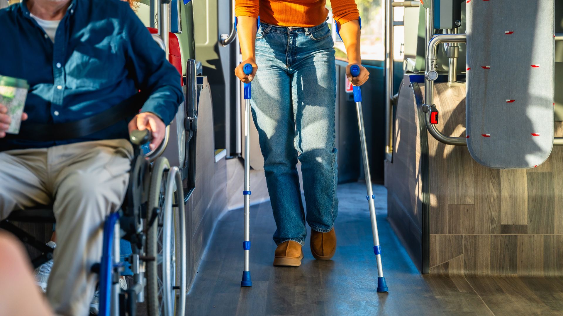 NDIS transport problems person using crutches on bus.